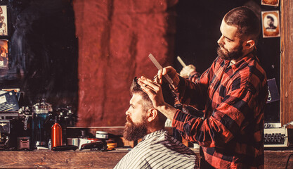 Man visiting hairstylist in barbershop. Bearded man in barbershop. Work in the barber shop. Man...