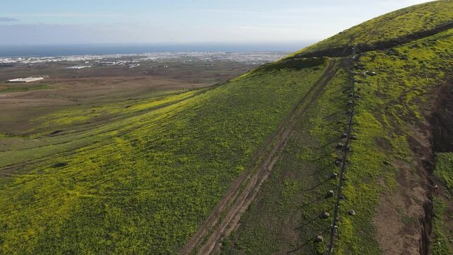 Drone aerial view landscape of the hills over Arrecife at the Canary island on Lanzarote in Spain
