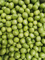 Top view of the hands holding green peas. Texture. Filled frame