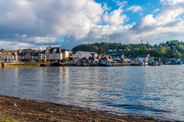 Fototapeta premium A view from the seafront towards the port in the town of Oban, Scotland on a summers evening