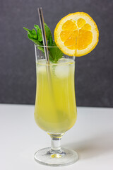 Pineapple cocktail with mint orange ice and straw