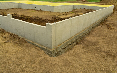 Concrete footings and basement walls complete and ready for the next phase of construction process.