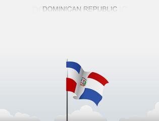 Dominican Republic flag flutters on a pole standing tall under a white sky