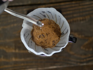 Fototapeta premium The process of brewing special coffee. Brewing coffee in a funnel. v-60 stages of brewing coffee. how to prepare a coffee filter, the brewing process. Work as a barista. Third wave coffee shop. 