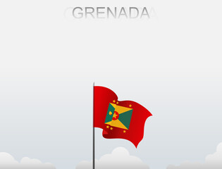 Grenada flag flutters on a pole standing tall under a white sky