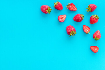 Group of ripe strawberries with green leaves. Flat lay