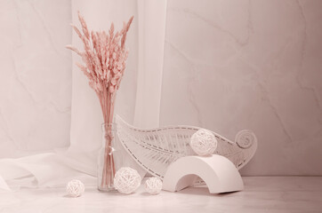 Trendy interior still life. Geometric shapes, decorative plate and dry plant in glass vase on a beige background.	