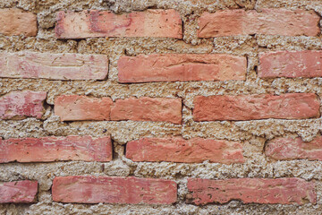Red brick wall constructed using cement to connect