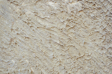 Gray cement walls use plastering techniques to create a rough, grooved surface.