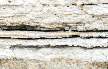 Beautiful natural cliff surface white limestone background. Multiple layer rock pattern with horizontal lines. Great texture for your design.
