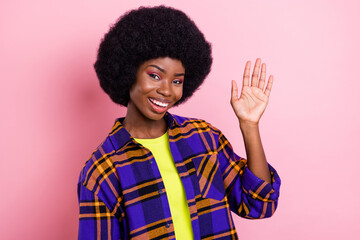 Portrait of attractive cheerful girl waving you hi hello greetings isolated over pink pastel color background © deagreez