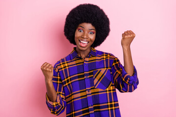 Portrait of attractive cheerful girl rejoicing having fun attainment isolated over pink pastel color background