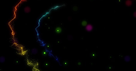 Blue red yellow and green trails of glowing dripping light rotating on black background