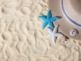 Seashells, a straw hat on the sand with space for text. Beautiful summer beach vacation.