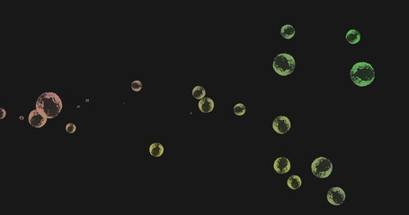 Image of multiple green and yellow bubbles floating across black background