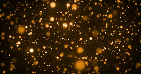 Image of glowing gold spots of light moving in hypnotic motion on brown background