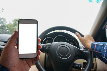 Using Mobile Phone Device While Driving. Cropped shot view Man looking smart phone in a car.