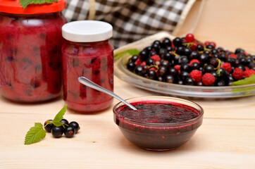 still life with currant jam in a bowl and glass jars