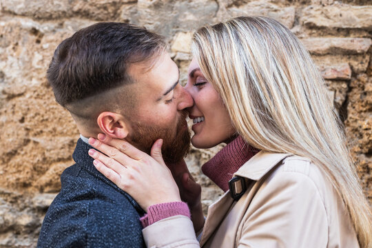 Loving couple kissing tenderly in street