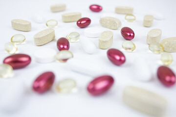 Different types of vitamins and pills on a white background. Can be used as a background. Copy space.