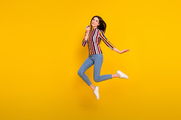 Fototapeta na wymiar Full body profile side photo of young woman happy positive smile jump up apply makeup pomade isolated over yellow color background