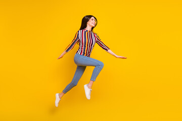 Fototapeta na wymiar Full size profile side photo of young woman happy positive smile jump up fly go walk run isolated over yellow color background