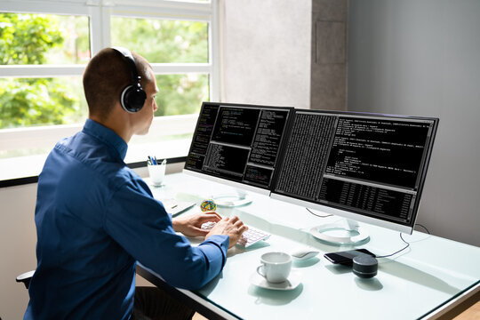 Computer Programmer Writing Program Code On Computer