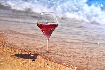 Wine glass with a cocktail by the sea.