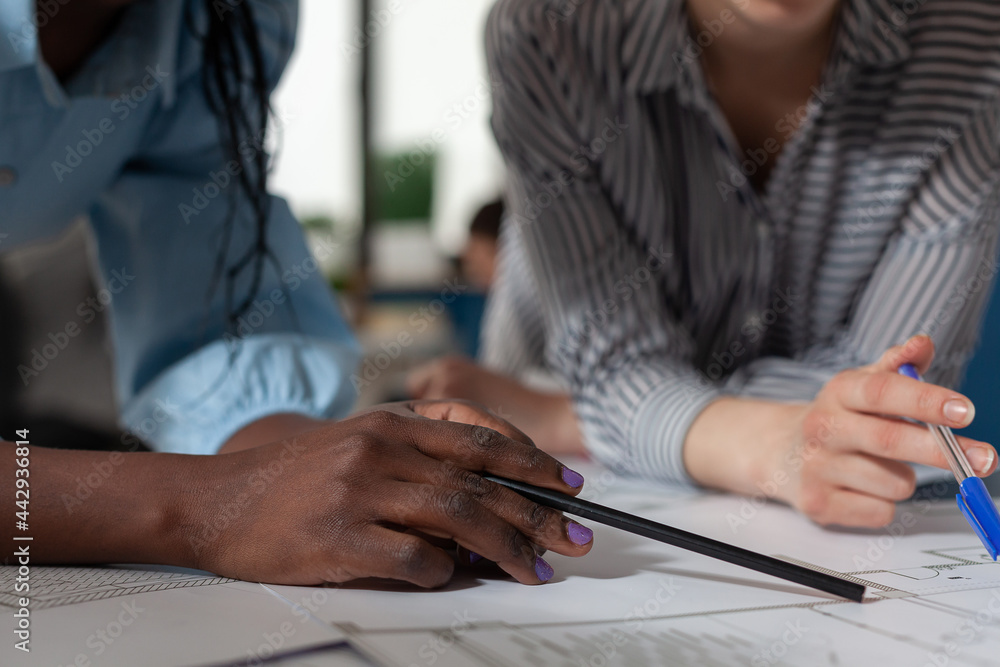 Poster close up of diverse architect women hands working on blueprint plans at desk. professional engineer 