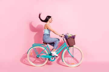 Full length body size photo woman riding retro bike in summer isolated pastel pink color background