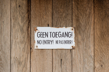 No Entry sign on a wooden door.