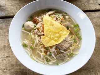 tom yum noodle on wooden table