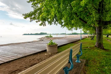 Foto op Canvas A wooden boardwalk and an empty beach after a rain storm in Toronto's Beaches neighbourhood shot in June. © Michael Connor Photo