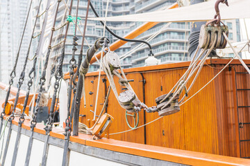 Details of rigging and wooden super structure on a tall ship moored in Toronto's Inner Harbour, shot on a summer morning.