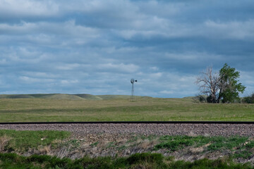 Fototapeta na wymiar Windmill and Train Tracks