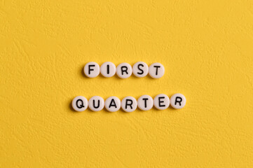 Alphabet letters with text FIRST QUARTER isolated on yellow background