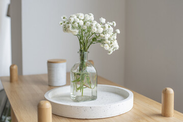 Fresh flowers in a glass vase in a bright interior