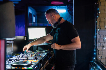 Inspired DJ using controller while performing with music improvi