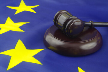Wooden judge gavel on European Union flag. Laws and court in EU concept.	