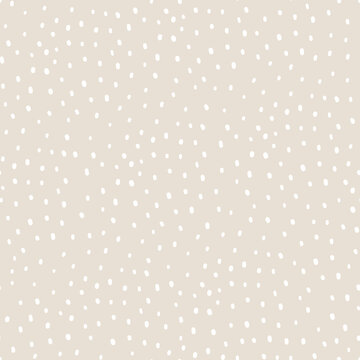 Vector abstract cute hand drawn seamless pattern with a irregular dots on a beige background. Pastel baby texture ideal for fabric, wallpaper, wrapping paper, card, layout. Delicate children's print.