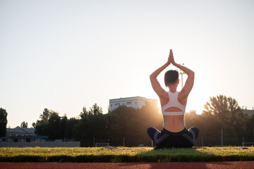 Sport and wellness. Fitness girl in white sneakers doing stretching workout. Fashion sporty woman with strong muscular body training. Fit female stretching at outdoor stadium