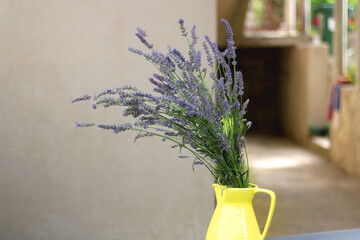 Yelow vase with fresh lavender flowers. Selective focus.