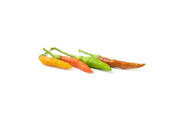 Fresh hot chili peppers of various colors are placed isolated on a white background.