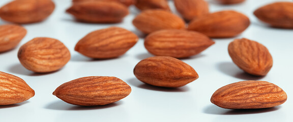 Background of almonds. Fried almonds. Scattered almond grains. Background for advertising
