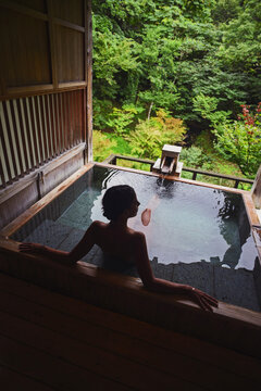 Silhouette of young caucasian woman in Japanese onsen