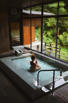 Young caucasian woman in thermal waters onsen