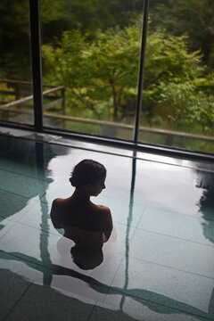 Silhouette of young caucasian woman in Japanese onsen