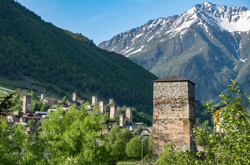Mestia village with typical Svan tower houses and snowy mountains at the background. Upper Svaneti, Georgia.