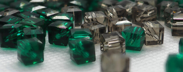 Green and gold glass beads stones, colored crystal cubes, glass stones background, asymmetrical...