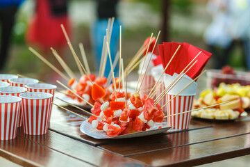 Table with colored sweet snacks. Outdoor party